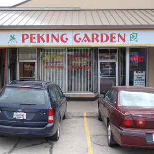 two cars parked in front of the store