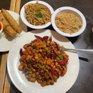 Kunpao chicken, egg rolls, fried rice, and noodles.