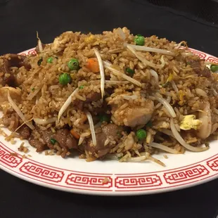 a plate of fried rice with meat and vegetables