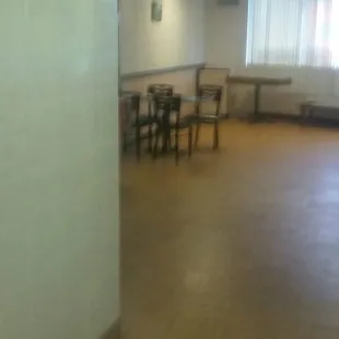 a view of a dining room with tables and chairs