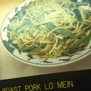 a plate of noodles with meat and vegetables