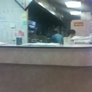 a man sitting at a counter in a restaurant