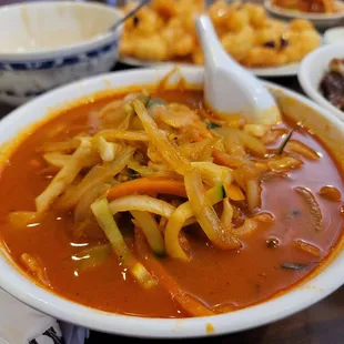 a bowl of soup with a spoon in it