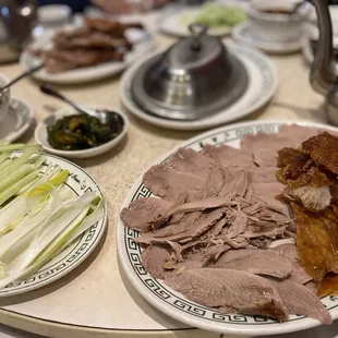 Pecking duck includes pancake, spring onion, cucumber and hoisin sauce