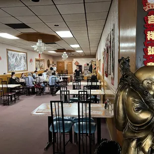 a restaurant with a statue of a monk