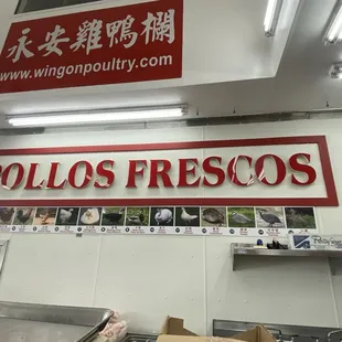 a sign above a counter in a restaurant