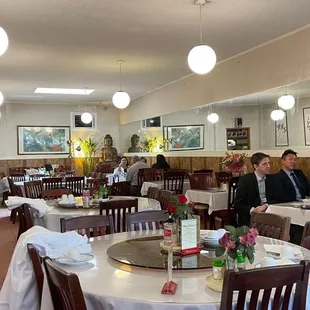 people sitting at tables in a restaurant
