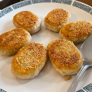 a plate of buns and a spoon