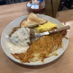 Chicken Fried Steak with white toast, scrambled eggs, and hash browns.