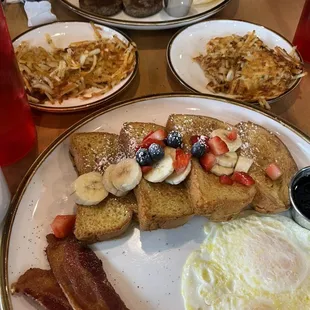 French toast with fruit, hashbrowns, eggs, bacon, and sausage