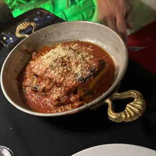 a bowl of pasta with sauce and parmesan cheese