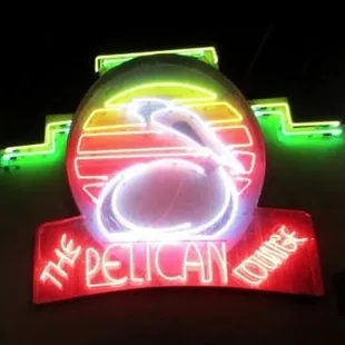 a neon sign for pelican lounge