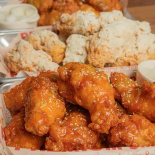 a tray of chicken wings and rice