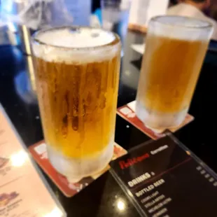 Models tap with frozen mug!