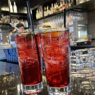 two cocktails on a bar