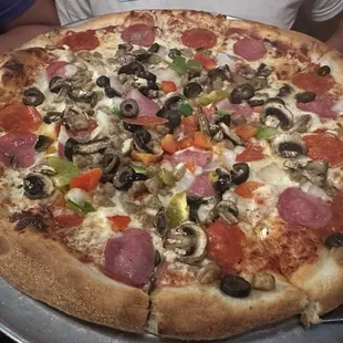 Loaded extra X Large Pizza With Canadian, bacon, pepperoni, hamburger, olives, green peppers, red peppers, onions