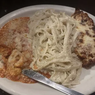 Combo plate with lasagna, fettuccine Alfredo, and chicken Parmesan.