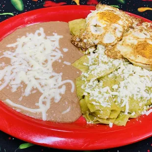 Chilaquiles- Sautéed corn tortillas with your choice of red or green salsa topped with queso fresco and sour cream. Serve with two eggs.
