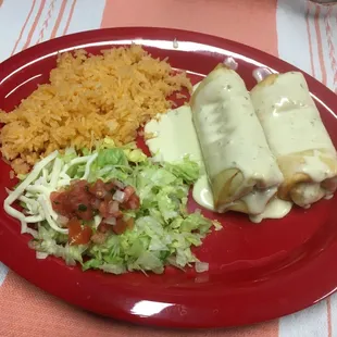 Chimichangas-  2 chicken or shredded beef chimichangas topped with cheese sauce, served with rice and tossed salad.