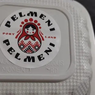 the logo on the lid of a white container