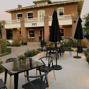 a patio with tables and chairs