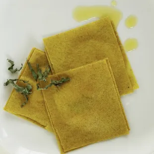 a plate of ravierole with a sprig of sage