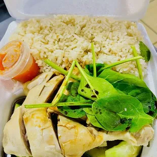 chicken, rice, and vegetables in a styrofoam container