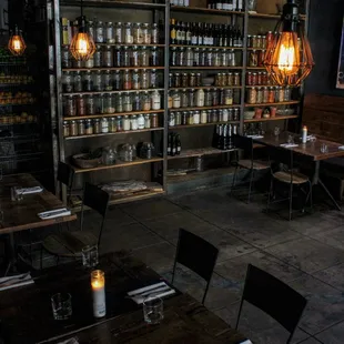 a dimly lit dining room with tables and chairs