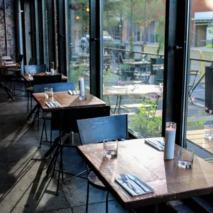 empty tables in a restaurant with large windows