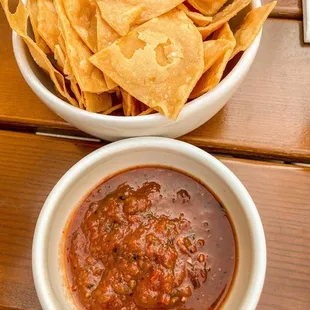 a bowl of chips and a bowl of salsa