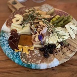 Charcuterie platter they put together for us on a cutting board we dropped off.