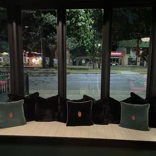 a window seat with pillows