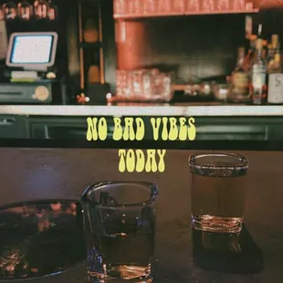 two shot glasses on a bar counter