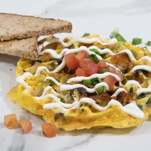Veggie Womelette

Green bell peppers, tomatoes, olives, green onions, tater tots, shredded cheddar cheese, eggs