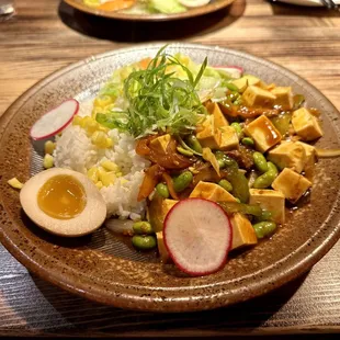 Ma Po Tofu Donburi - firm tofu in a spicy sauce, with green and red pepper, onion, soy beans, corn, served with rice and a soft boiled egg