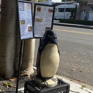 Penguin and menu in front of the Cafe