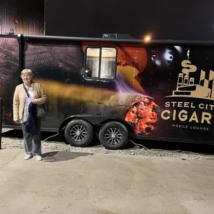 a man standing in front of a trailer