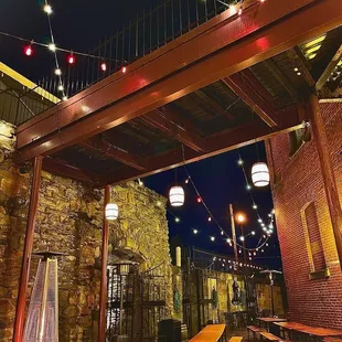 cobblestone biergarten by night, magical with propane heaters