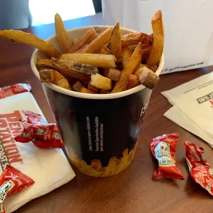 a cup of fries and a bag of chips