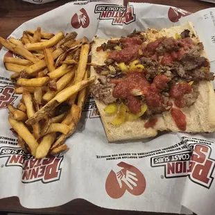 Philly steak sandwich with banana peppers and a little pizza sauce for extra flavor