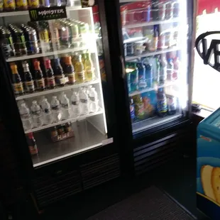 two refrigerators with drinks in them