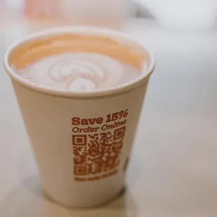 a cup of coffee with a qr code on it