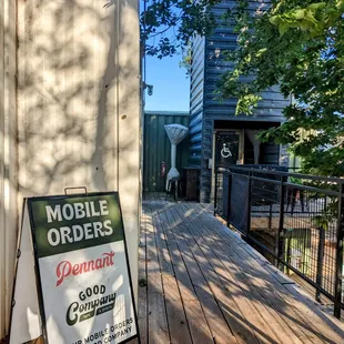 a mobile orders sign on a porch
