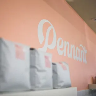 a pink wall with white lettering