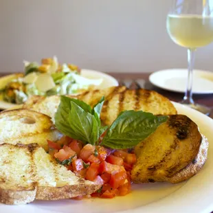 a plate of food and a glass of wine
