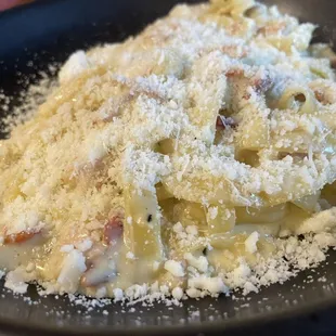 Carbonara Pazza - Tagliatelle Pasta covered in a creamy egg yolk sauce and topped with crunchy Pancetta (Italian Bacon)