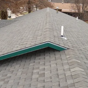 the roof of a house with a green trim