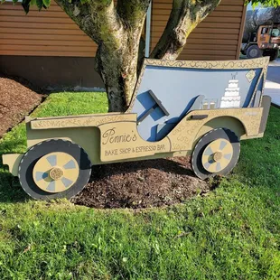 a wooden jeep with a sign on the back