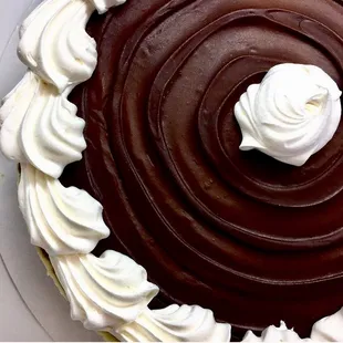 Traditional Cheesecake with a poured chocolate glaze.