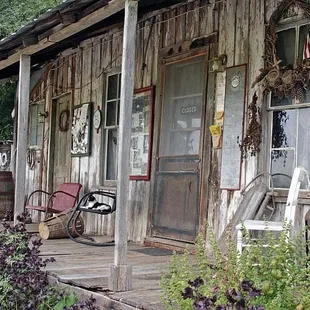 an old wooden building with a porch